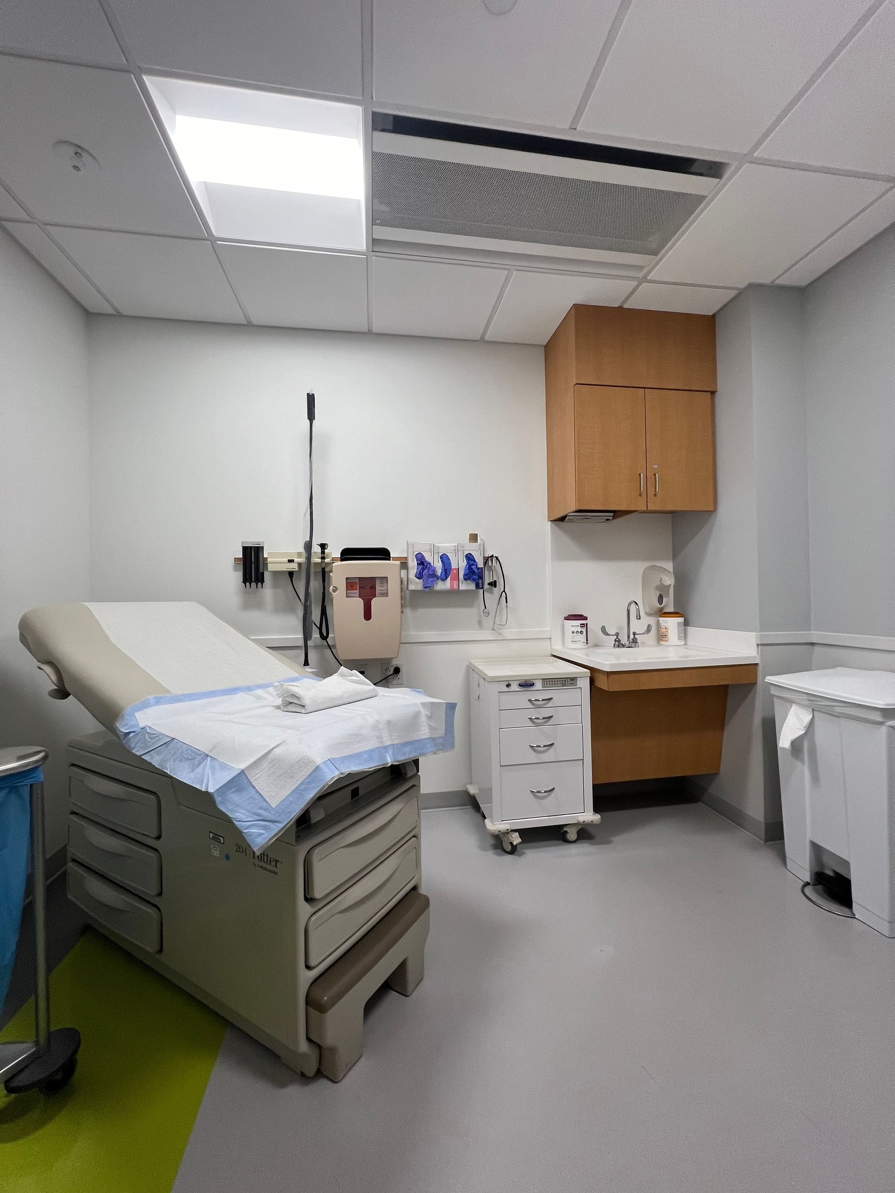 The finished exam room from the doorway, exam table and casework ready for the tenant