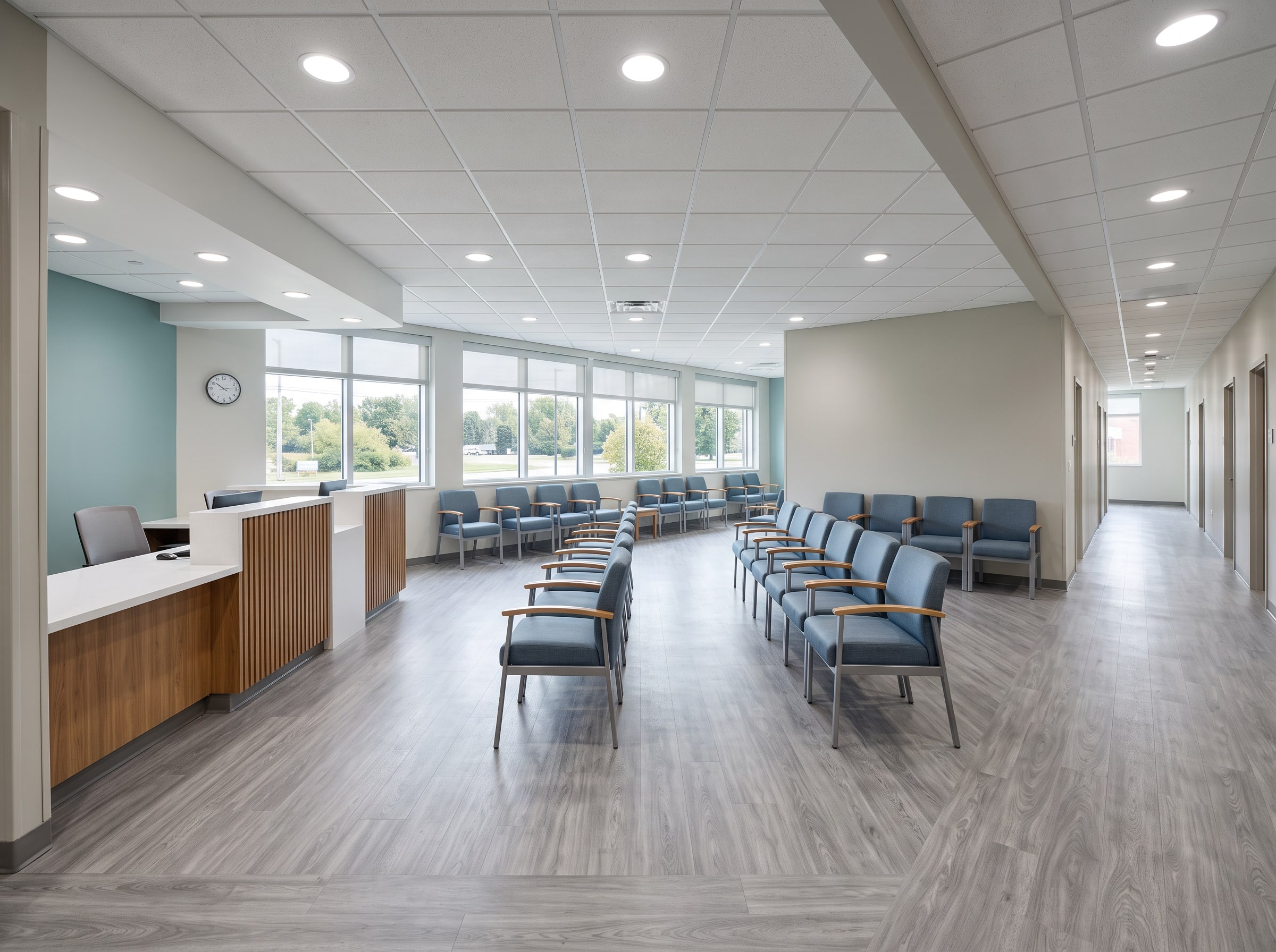 The same waiting room back in service: new chairs, check-in counter, teal feature wall and new floor