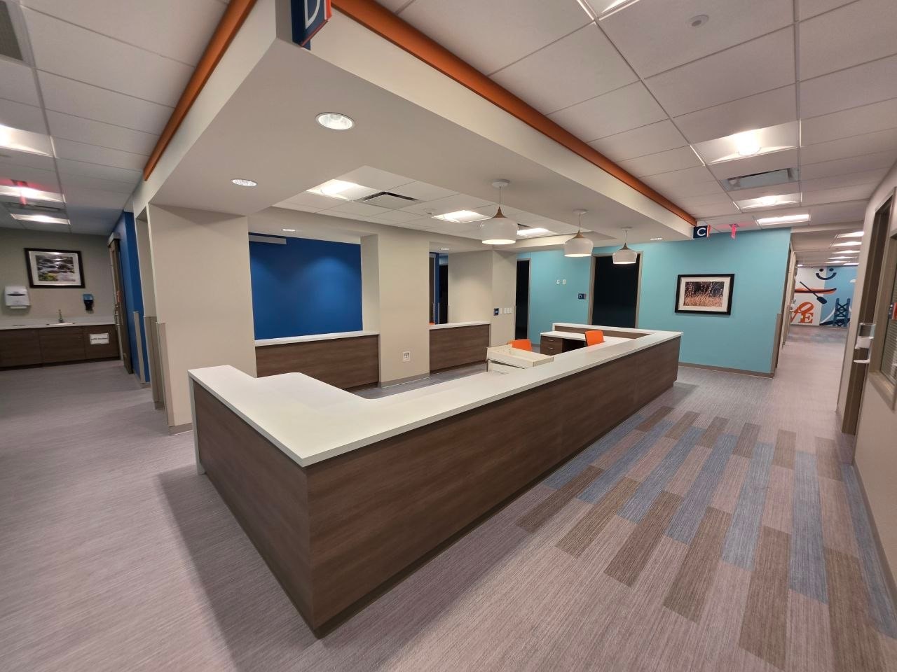 A finished reception and nurse station seen from the corridor