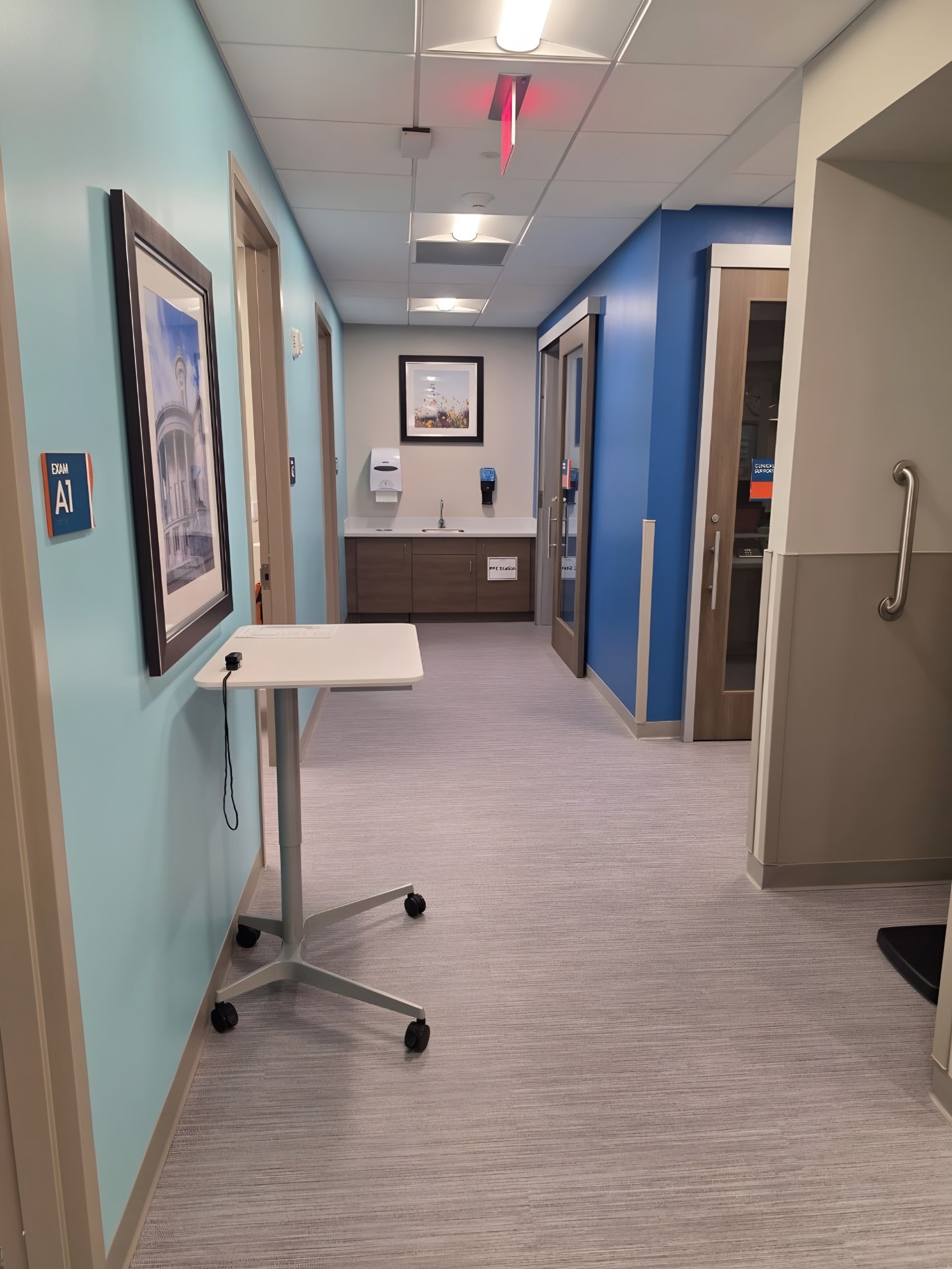 A finished exam room with casework and a diagnostic wall unit