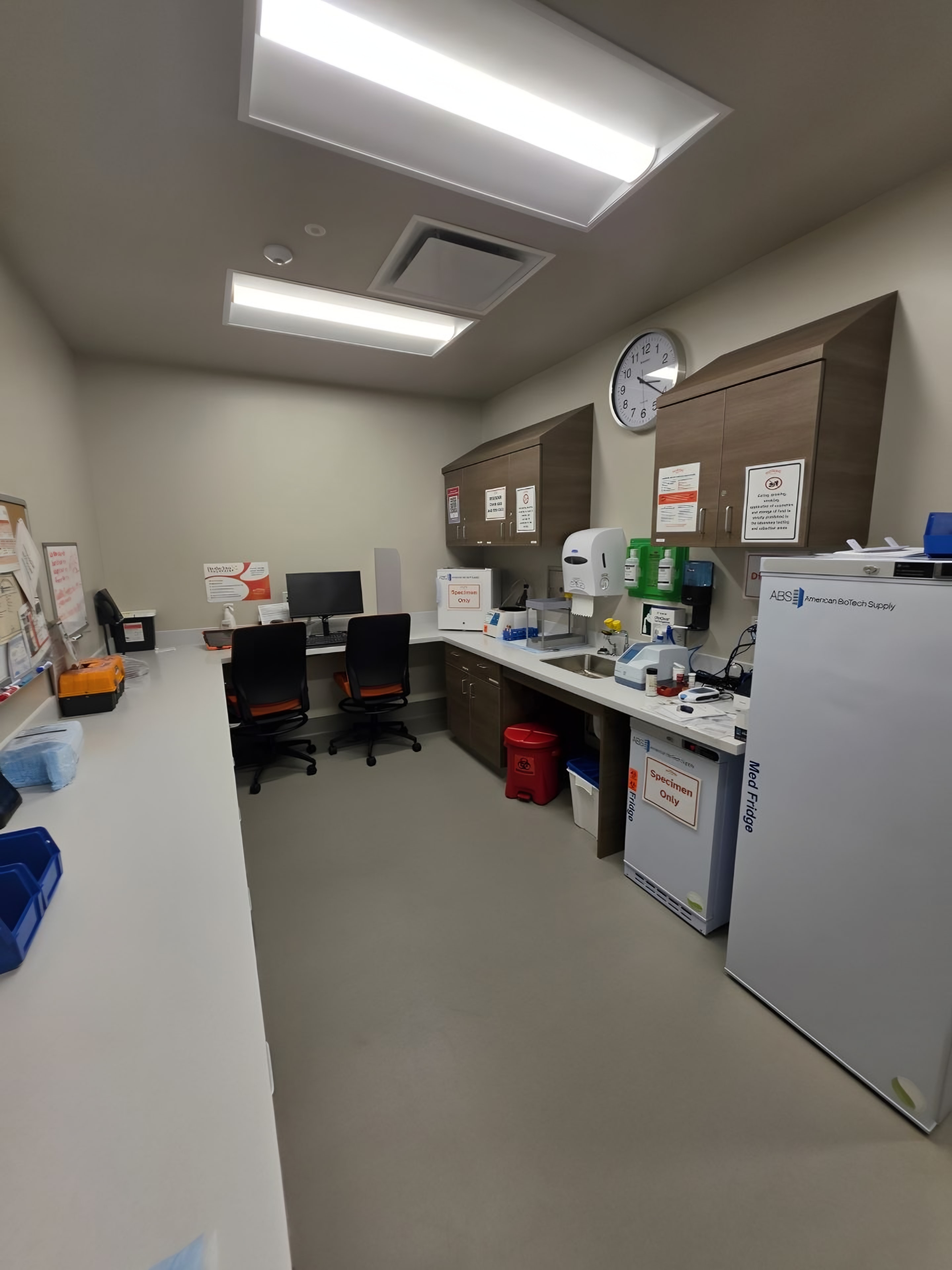 A finished lab and blood-draw room with a casework run and sheet flooring