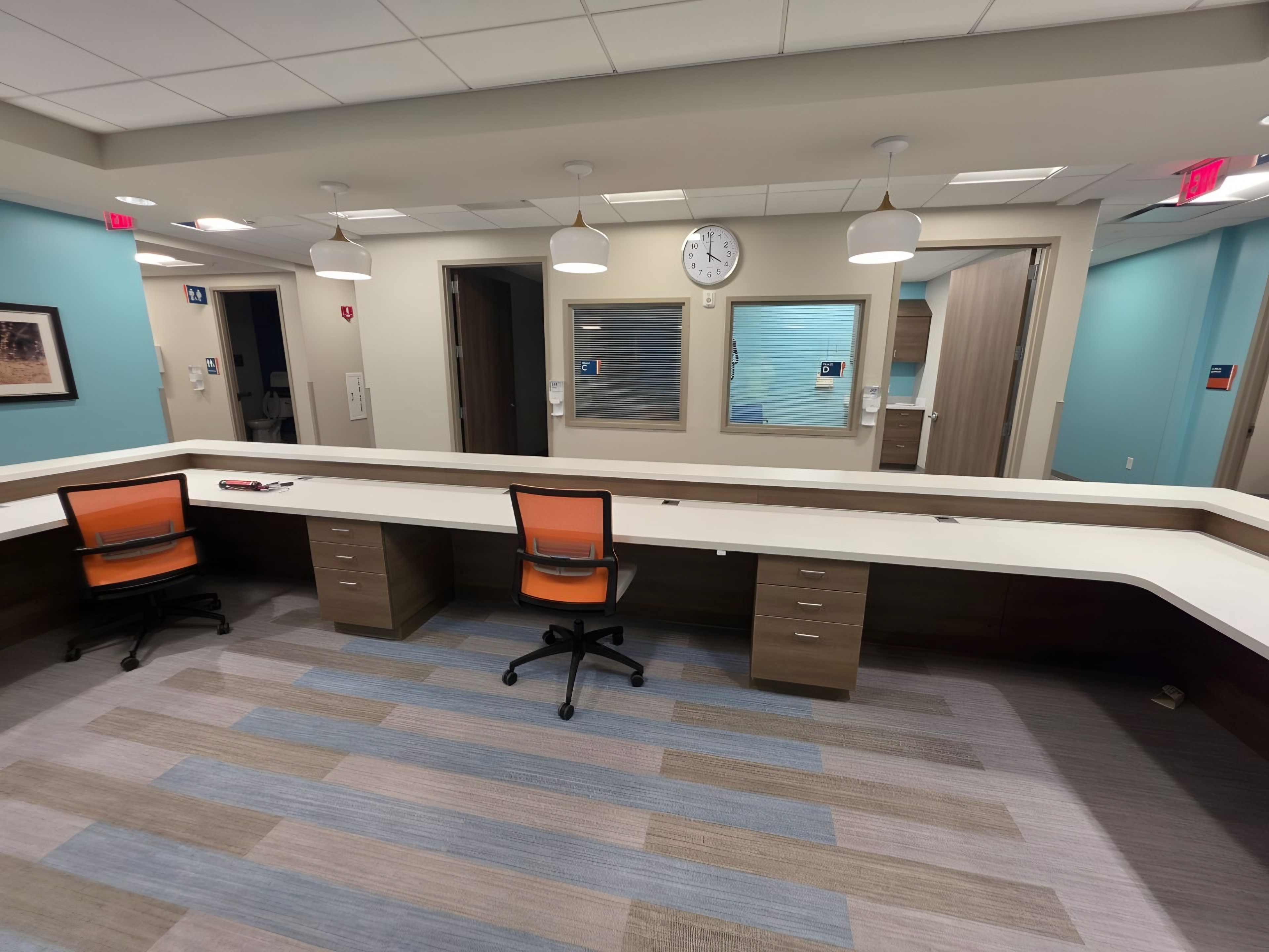 A finished staff work counter with vision panels into the clinic