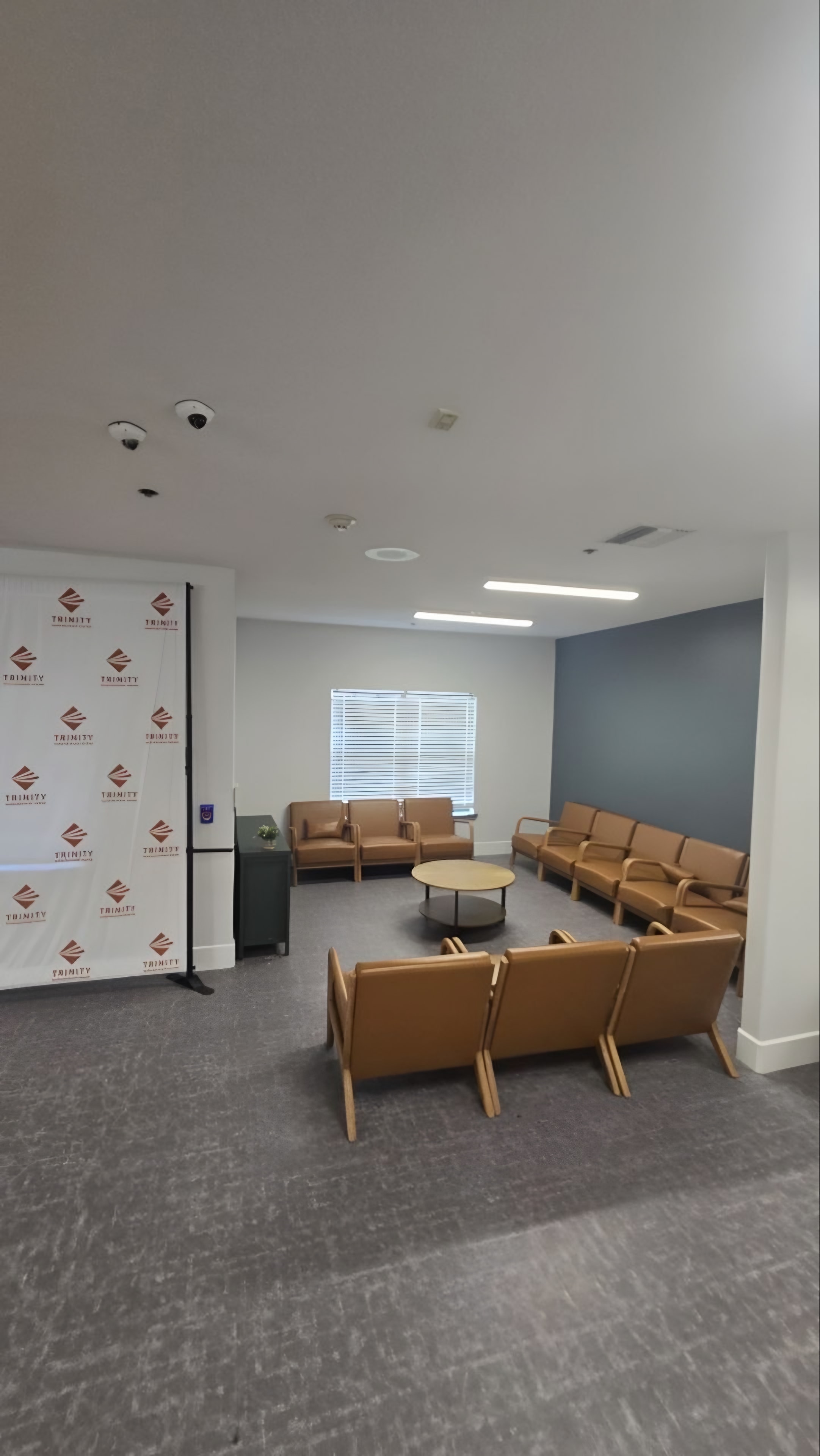 A finished lounge in a residential treatment facility with tan leather chairs