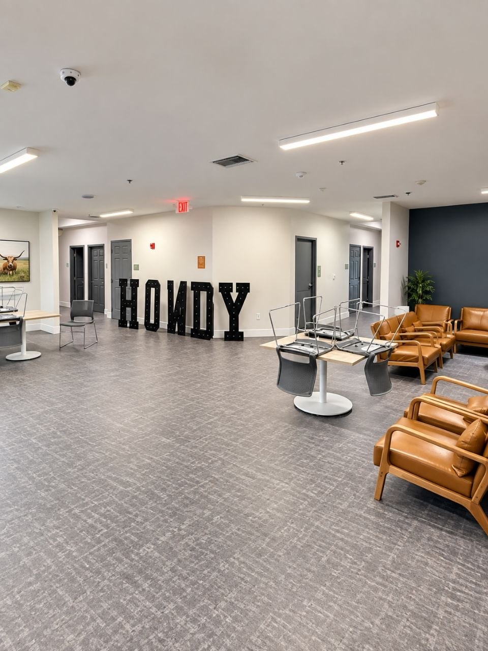 A finished common room with seating and large marquee letters