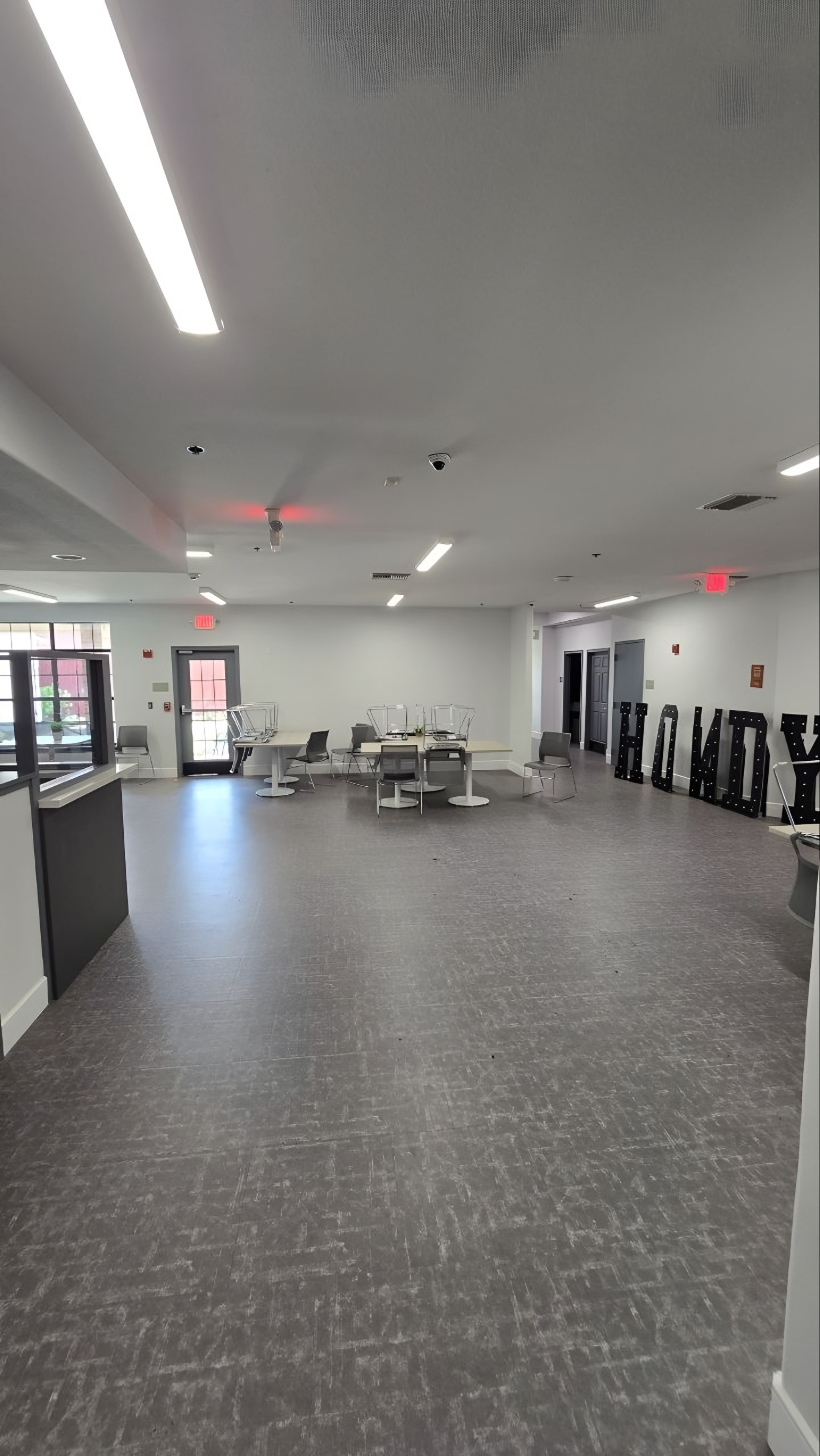 A finished open common room with seating and tables