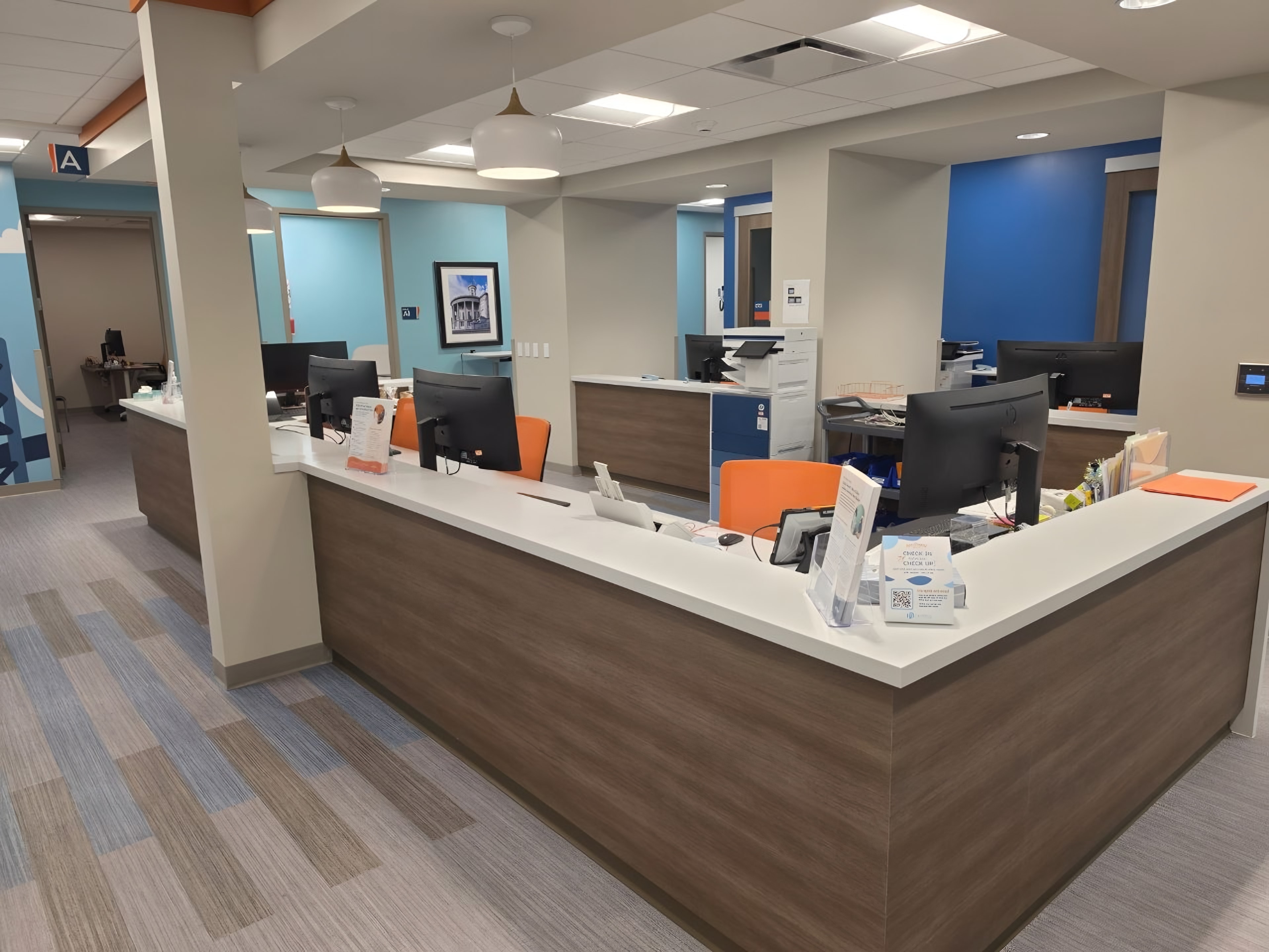 A finished nurse station with a solid-surface counter and wood casework
