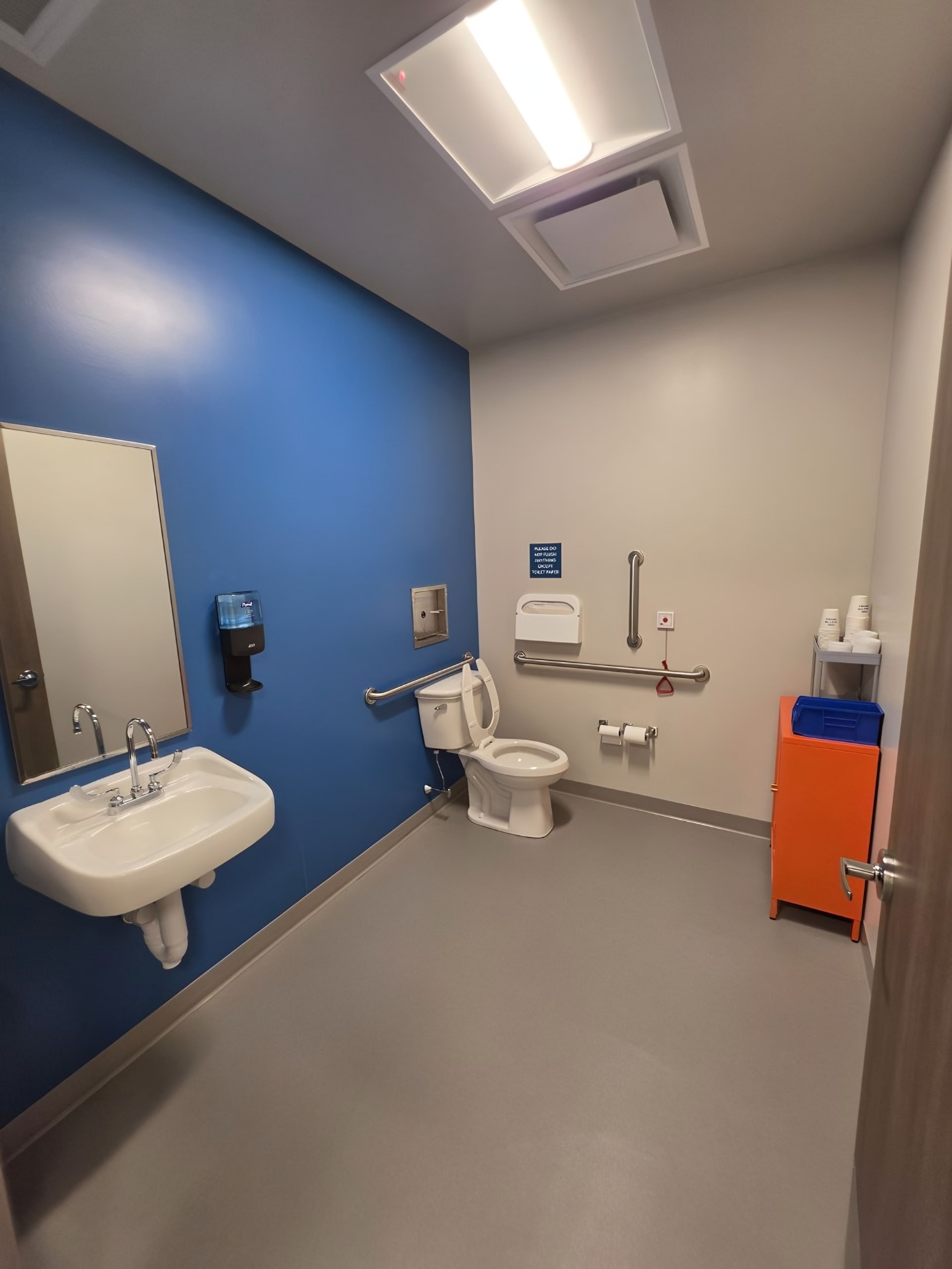 A restroom with a blue accent wall