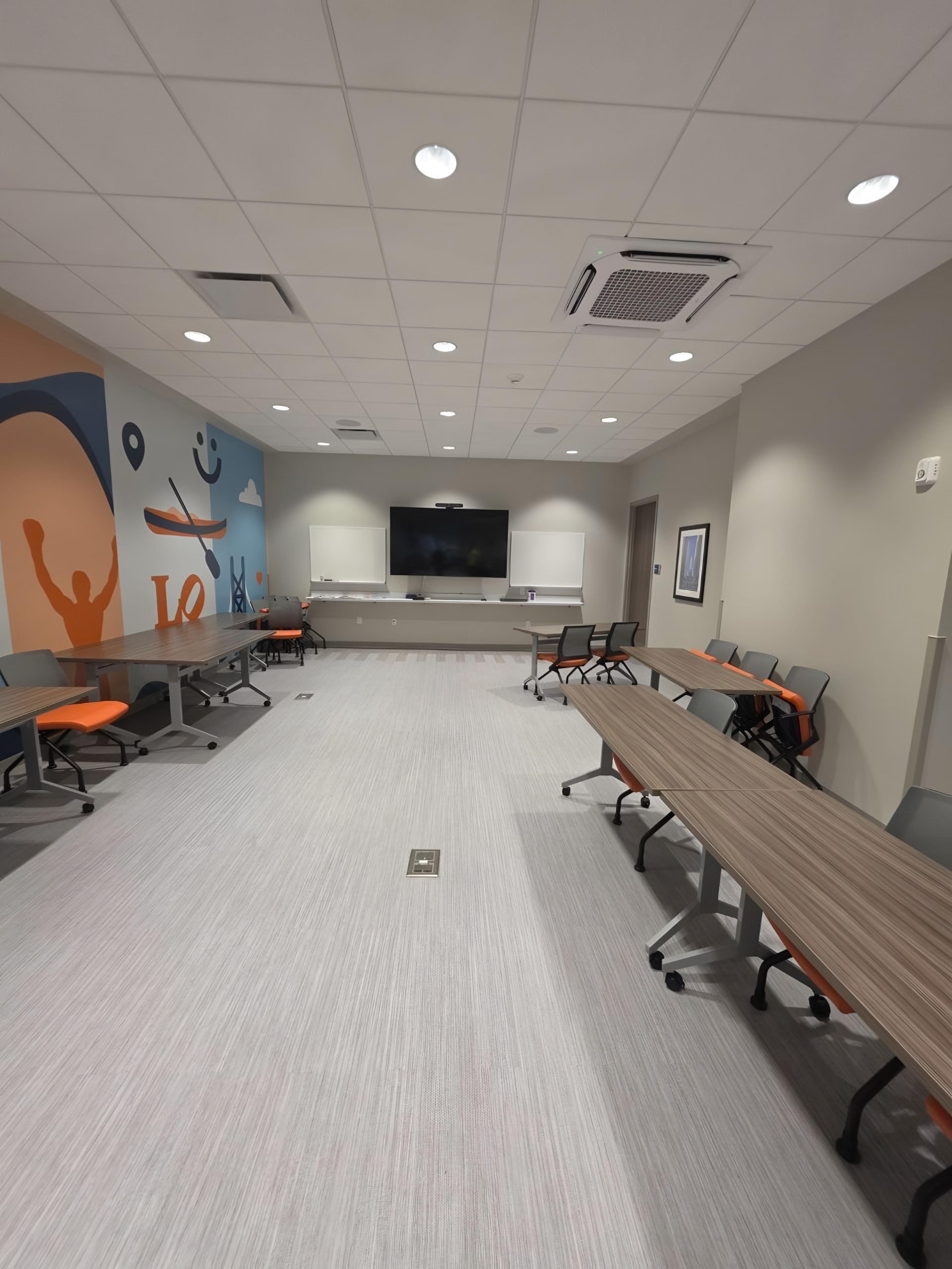 A conference room with a painted mural wall