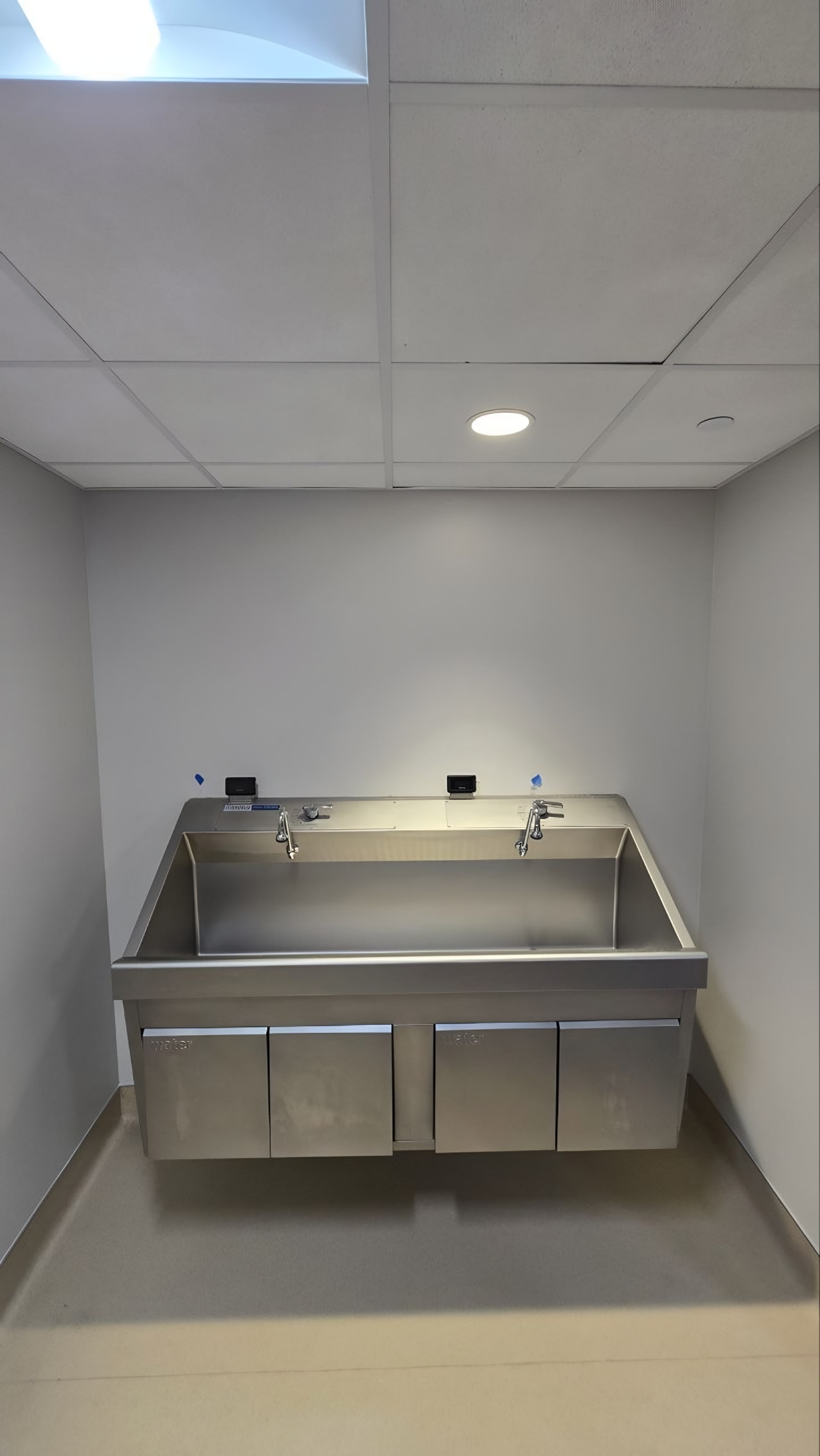A stainless steel wash trough with sensor faucets
