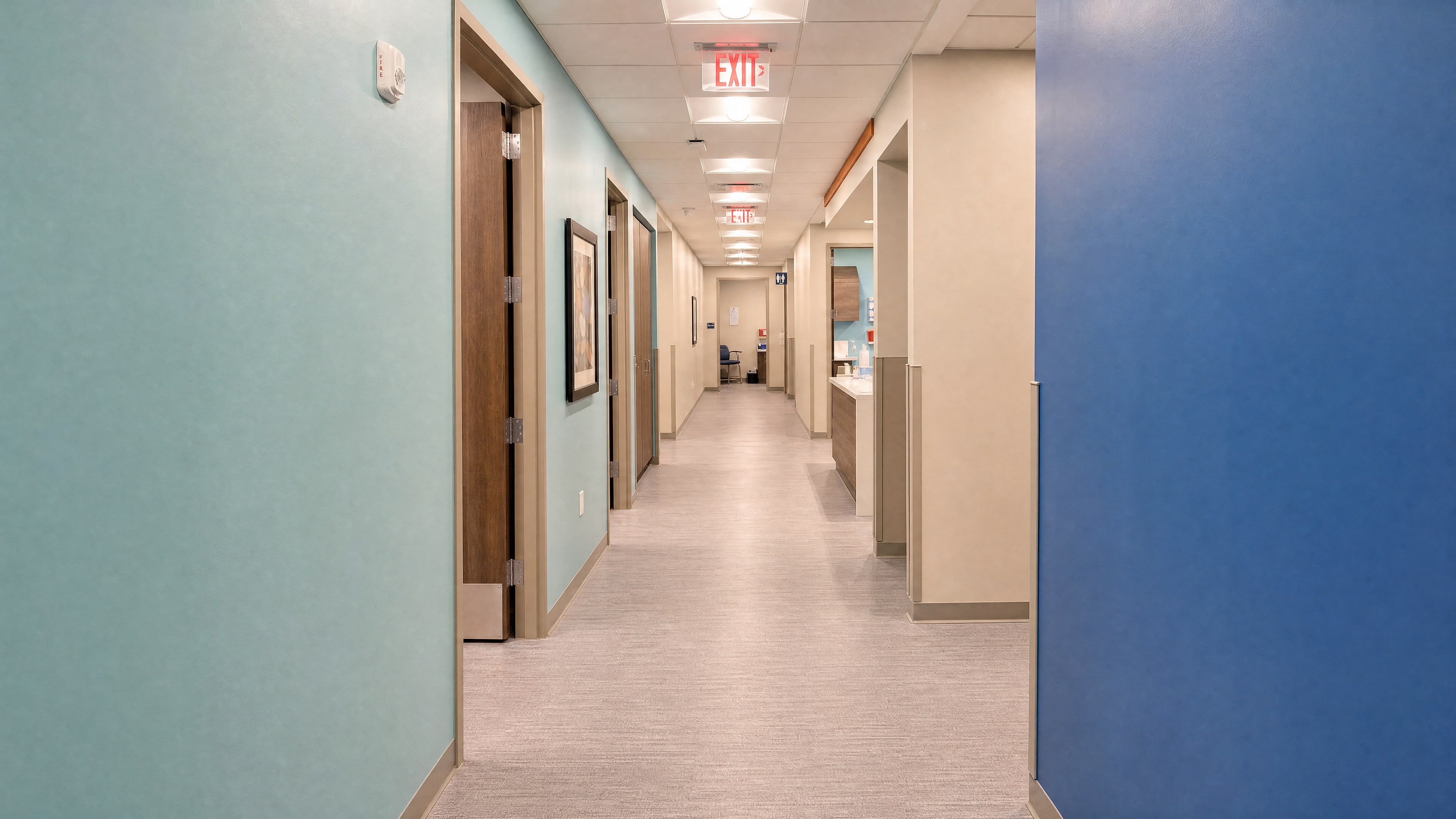 A freshly painted corridor with teal and blue accent walls